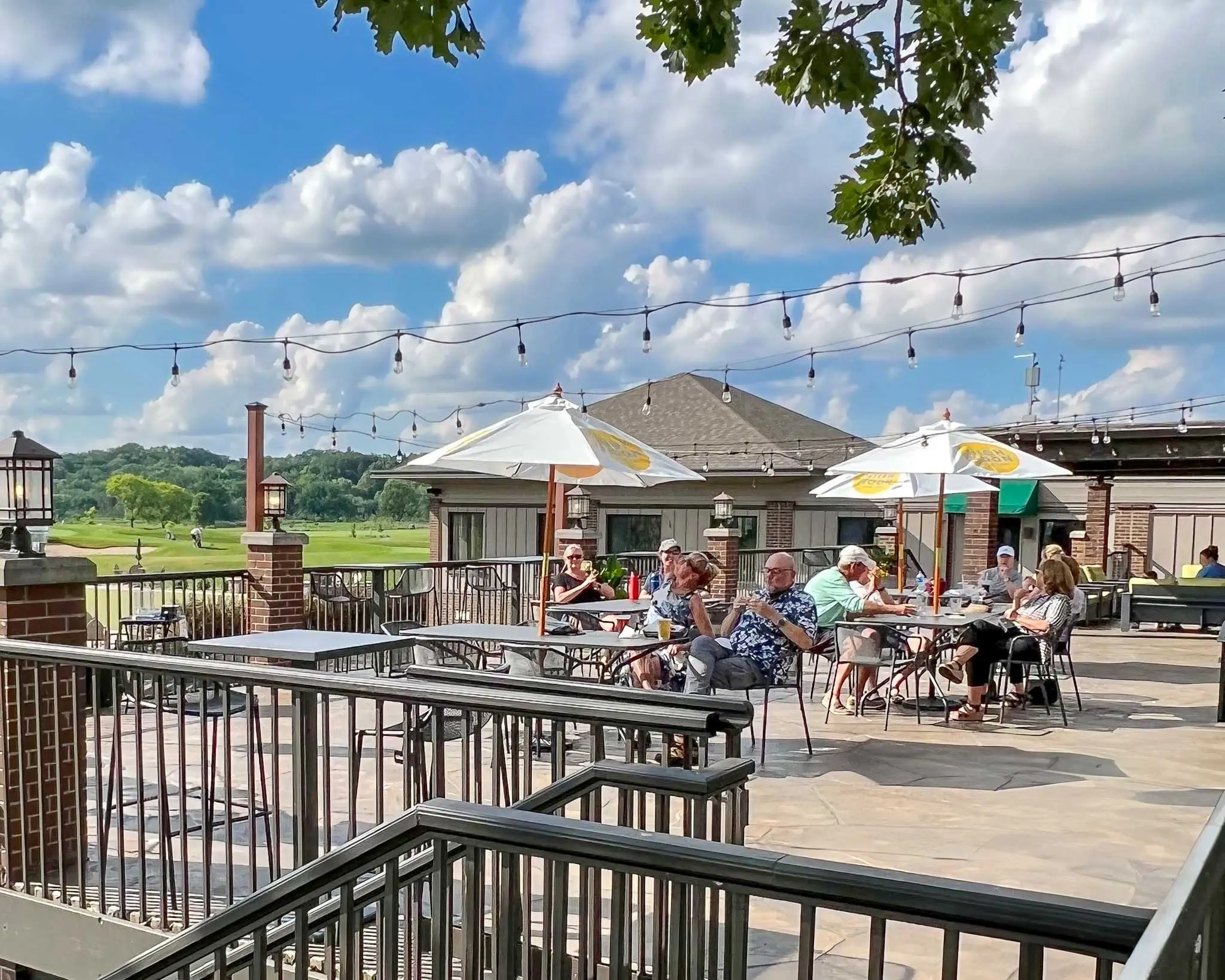 Customers sitting on patio overlooking course